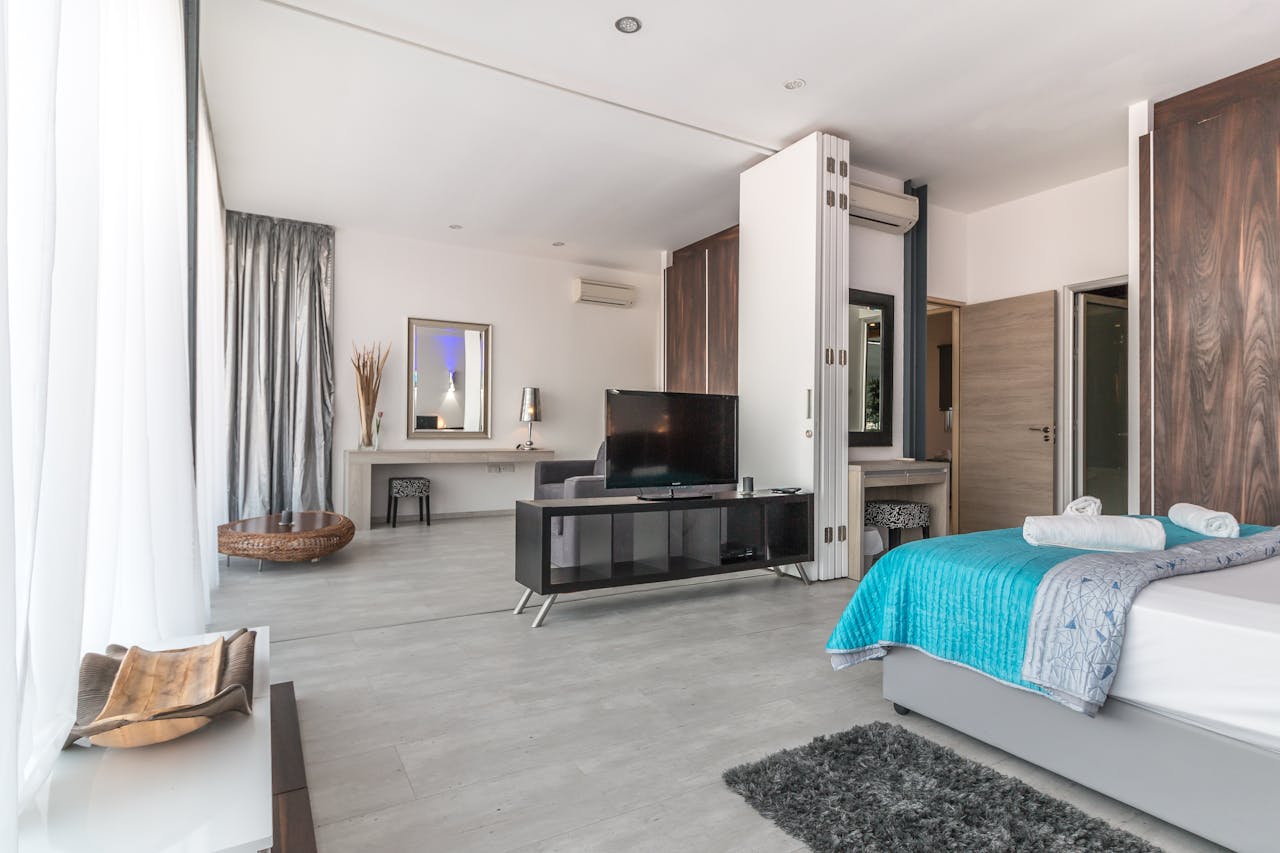 mission-img Spacious and modern bedroom with sleek design, featuring elegant decor and natural lighting.